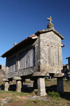 A very old corn drier, made of stone isolated over blue sky background