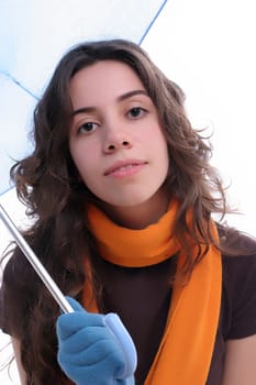 Young woman under an umbrella, posing over white background
