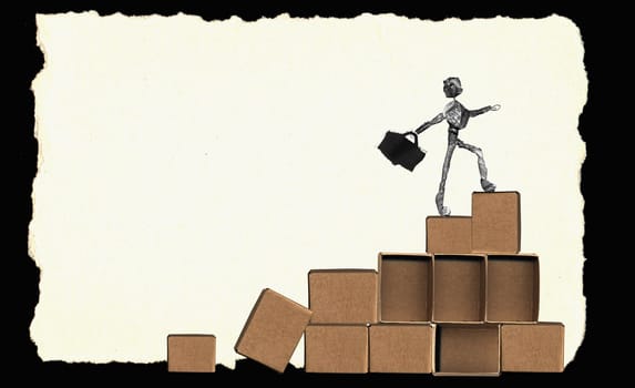 Close-up of a newspaper figurine walking on boxes