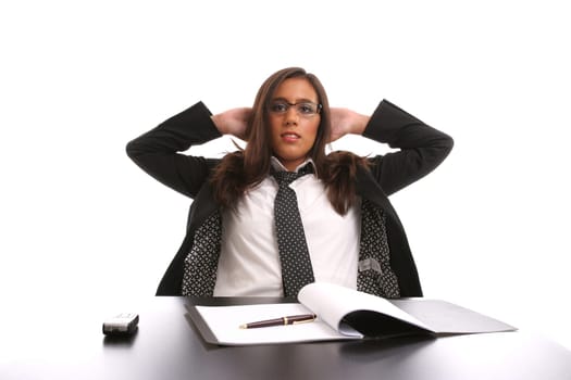 Successful businesswoman relaxing over her desk, isolated in white background