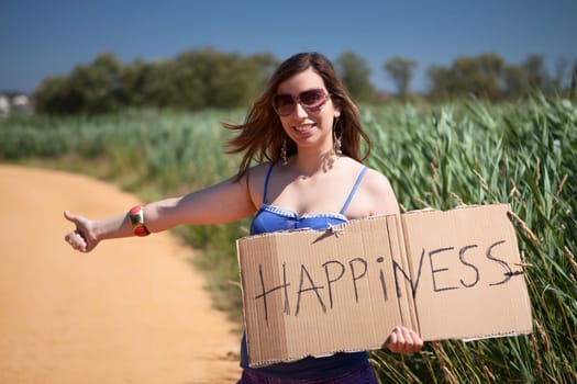 Pretty young woman holding happiness card