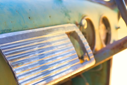 Abstract chrome vintage car dashboard with selective focus and soft golden hour lighting.