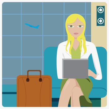 Businesswoman sitting in airport and using a laptop