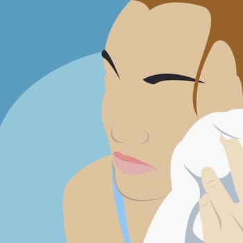 Young woman wiping her face with a towel