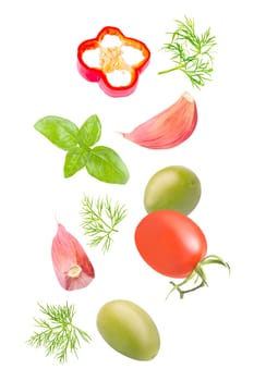 Isolated vegetables. Mixed tomatoes, dill, green olives, basil, bell pepper and garlic falling down on white with clipping path as package design element. Full depth of field.