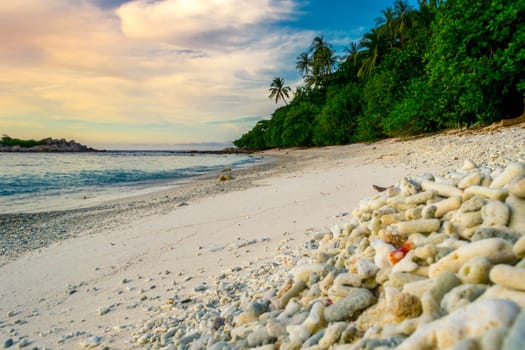 Peaceful and tropical coral turtle beach at Perhentian Islands, Malaysia, long exposure, with cloudy sky during sunset.. Postcard, mural or wallpaper about Malaysian tourism or travel