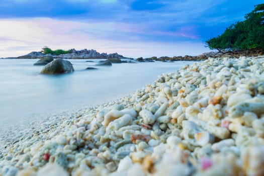 Peaceful and tropical coral turtle beach at Perhentian Islands, Malaysia, long exposure, with cloudy sky during sunset.. Postcard, mural or wallpaper about Malaysian tourism or travel