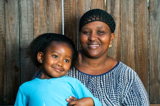 Portrait of young african mother with little daughter.