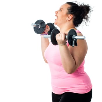 Close up side view of obese girl doing workout with weights.Isolated on white background.