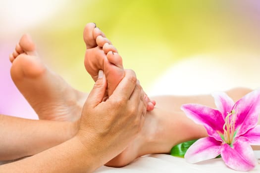 Extreme close up of female Spa therapist doing foot massage.