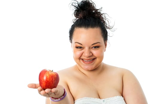 Portrait of overweight teen girl holding red apple.Isolated on white background.
