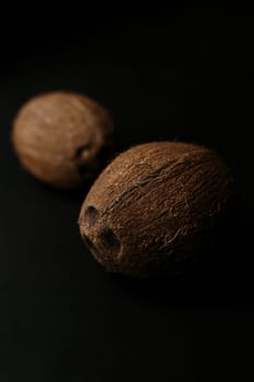 Raw coconut on the black background. Blurred background. High quality photo