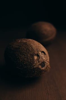 Raw coconut on the wooden oak table. Blurred background. High quality photo