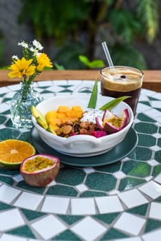 Granola with greek yogurt, honey, fresh fruits, chia seeds served with ice americano