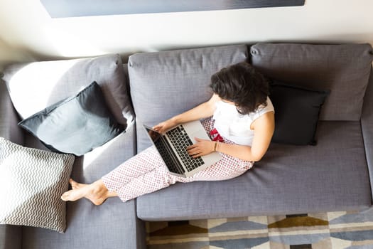 Beautiful woman relaxing with a computer