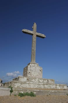 big cross isolated in blue sky, at sunset