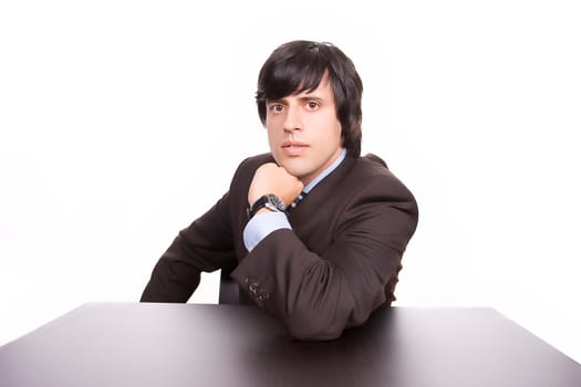 Young Businessman over a desk, full of thoughts, isolated in white
