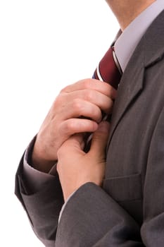 Business man fixing his tie, isolated over white