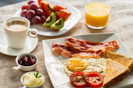 Close up of english breakfast with fresh fruit and coffee.