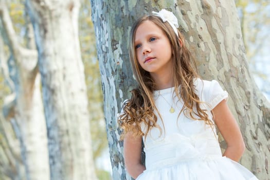 Close up portrait of attractive girl in white outdoors.