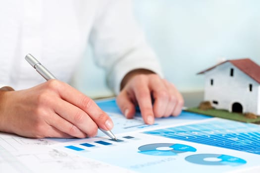Female analyst reviewing home budget statistics.
