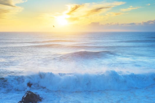 Waves at Atlantic ocean at sunset. Nazare, Portugal