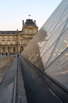 PARIS - AUGUST 15, 2016 Louvre museum at twilight in summer. Louvre Museum is one of the world's largest museums, every year museum visits are more than 8 million visitors.