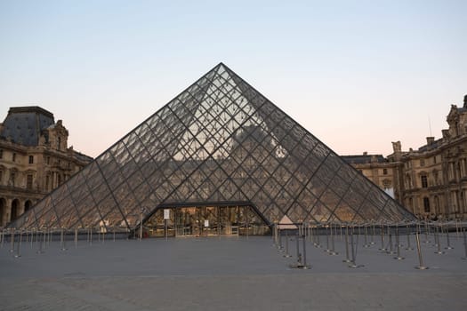 PARIS - AUGUST 15, 2016 Louvre museum at twilight in summer. Louvre Museum is one of the world's largest museums, every year museum visits are more than 8 million visitors.