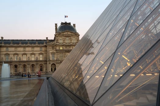 PARIS - AUGUST 15, 2016 Louvre museum at twilight in summer. Louvre Museum is one of the world's largest museums, every year museum visits are more than 8 million visitors.