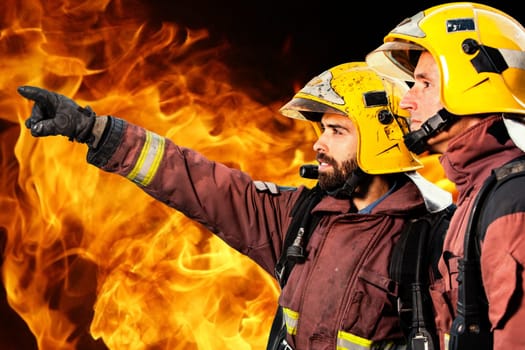 Fireman showing companion possible fire against Orange and yellow flames in background...