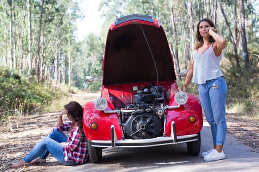 Friends on a roadtrip having a problem with their old car