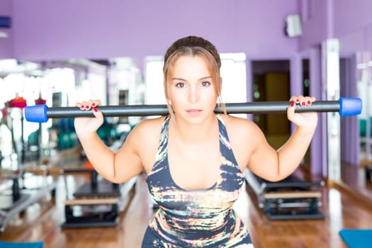Young woman getting into shape at the gym