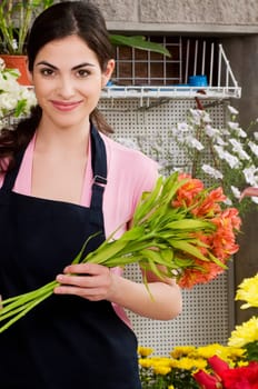 Woman holding a bouquet of flowers and smiling