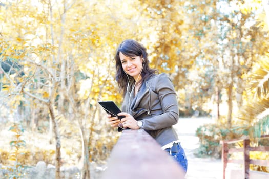 Young woman relaxing at the park with a tablet computer