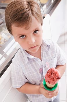 Portrait of a boy holding an ice cream