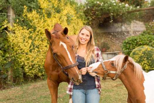 Beautiful and natural young woman spending sometime with her horse