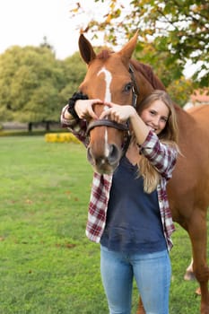 Beautiful and natural young woman spending sometime with her horse