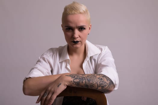 Studio shot of a young tattooed woman
