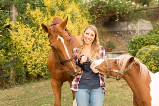 Beautiful and natural young woman spending sometime with her horse