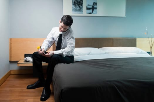 Businessman talking on the telephone and writing