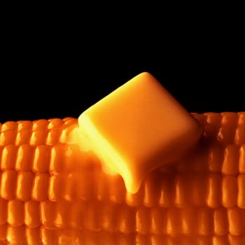 Close_up of a slice of butter melting on a corn