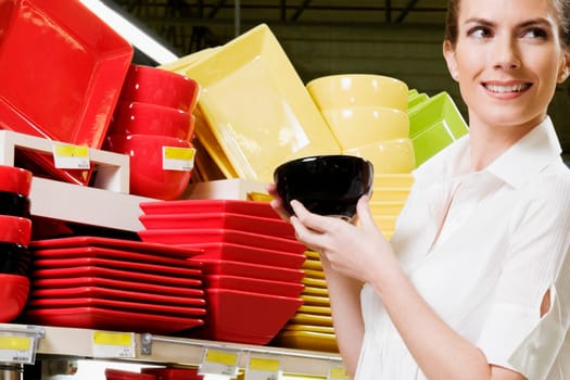 Woman buying crockery in a supermarket
