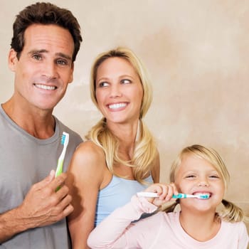 Family brushing teeth in the bathroom