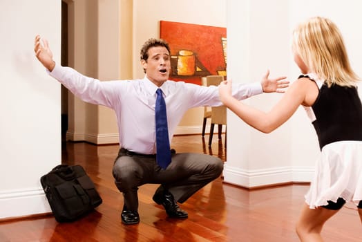 Businessman receiving a warm welcome from his daughter