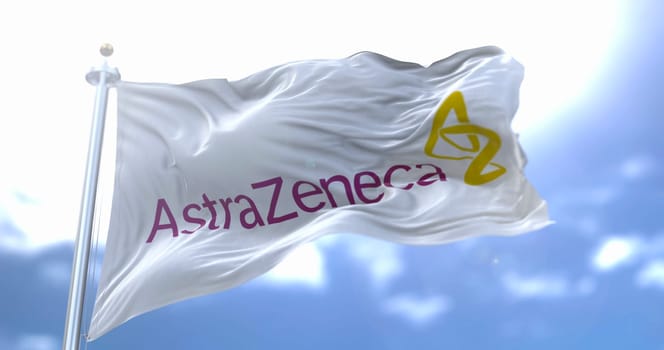 Rome, Italy, January 26, 2021: White flag with the new Astrazeneca logo waving in the wind. Astrazeneca is an British pharmaceutical company that has produced a vaccine for the Covid-19 coronavirus