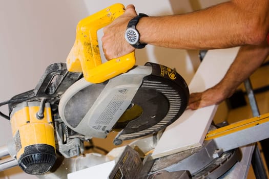Close_up of a personŽs hand using a circular saw