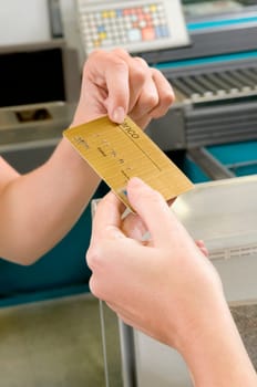 Customer making payment through credit card at the checkout counter