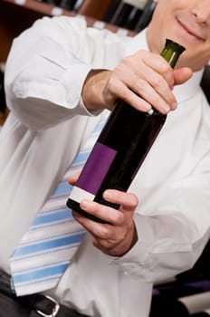 Businessman showing a wine bottle