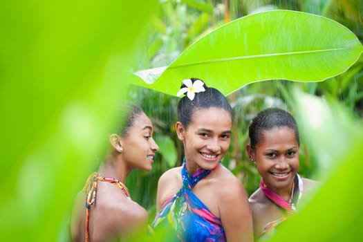 Teenage girl with her friends enjoying rain