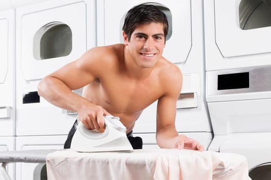 Man ironing in a laundromat